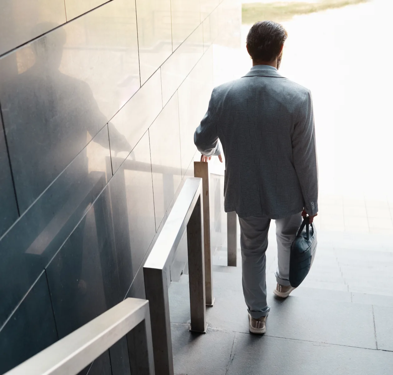 Businessman with a briefcase walking through an office entrance