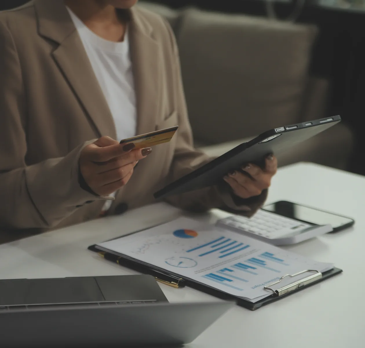 Person reviewing financial charts on a clipboard