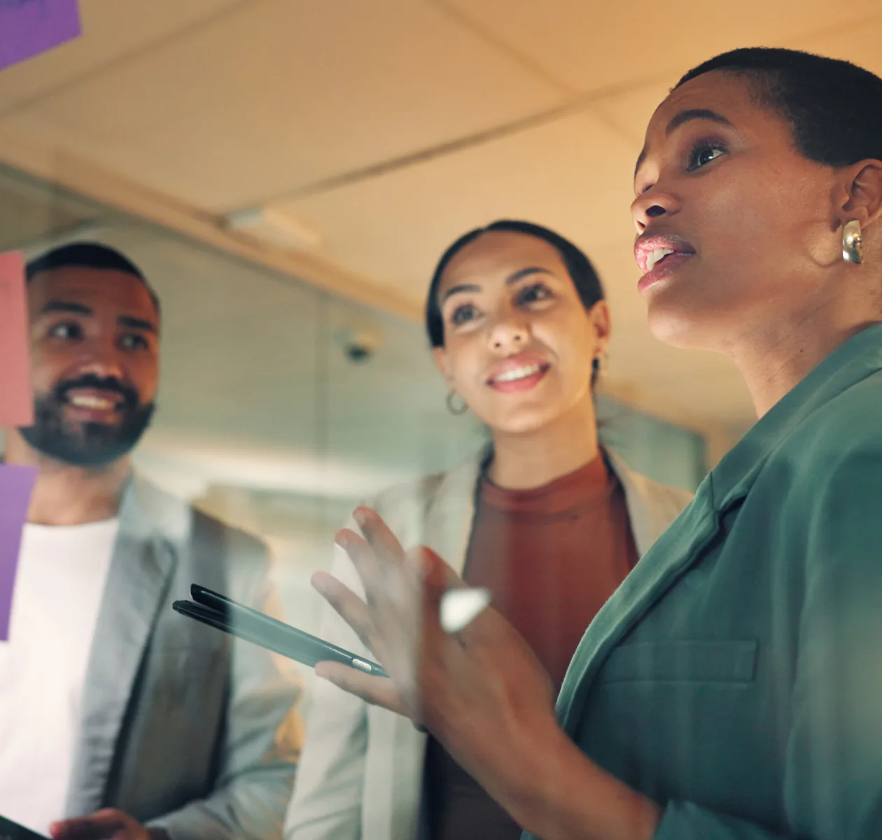 Three colleagues talking together in an office