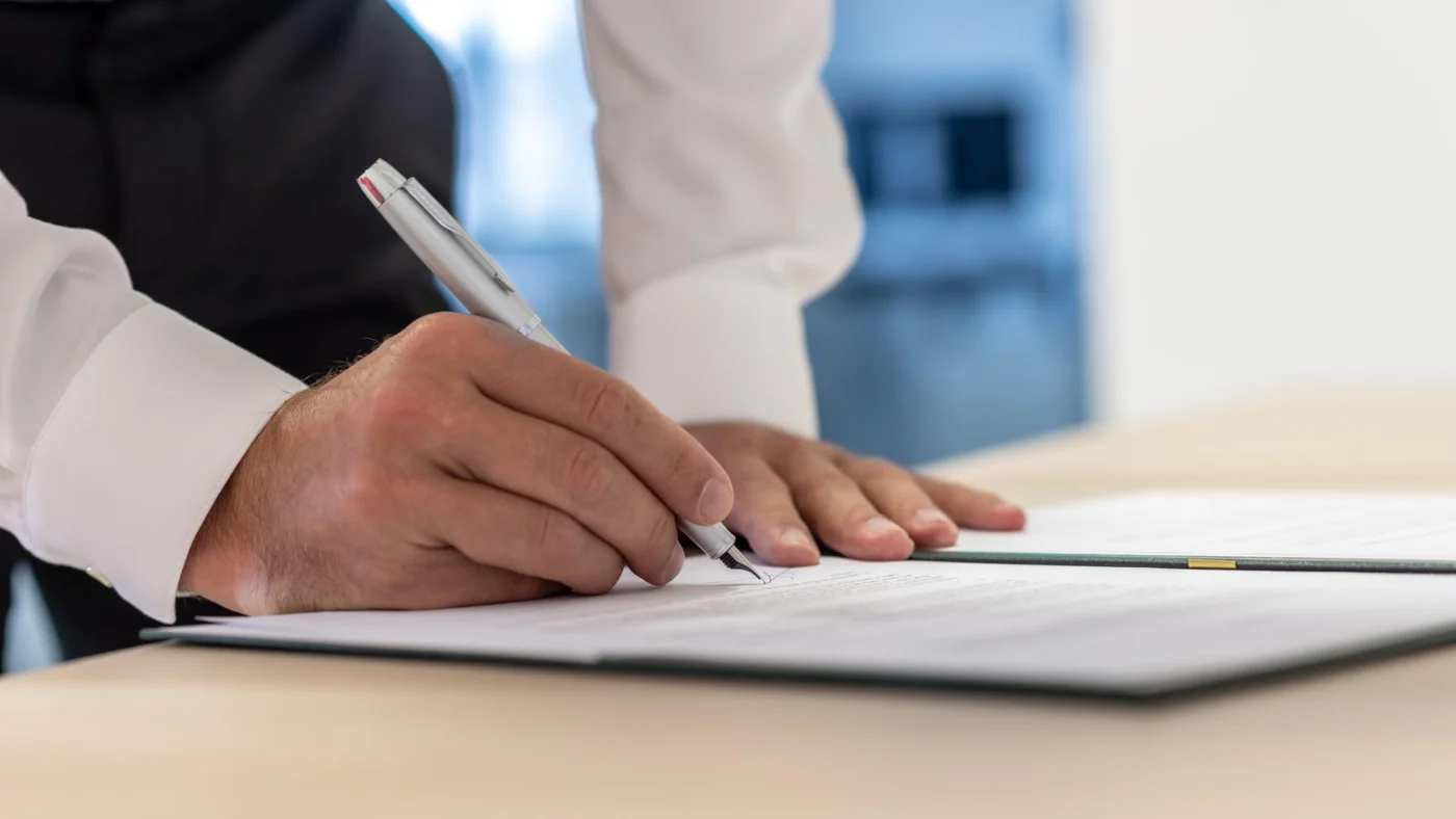 Two business partners reviewing figures and incorporation documents together at a desk