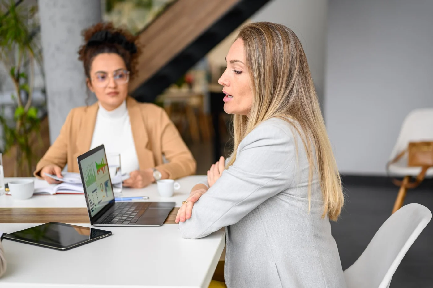 A reassured business owner reviewing tidy financial records with a new adviser