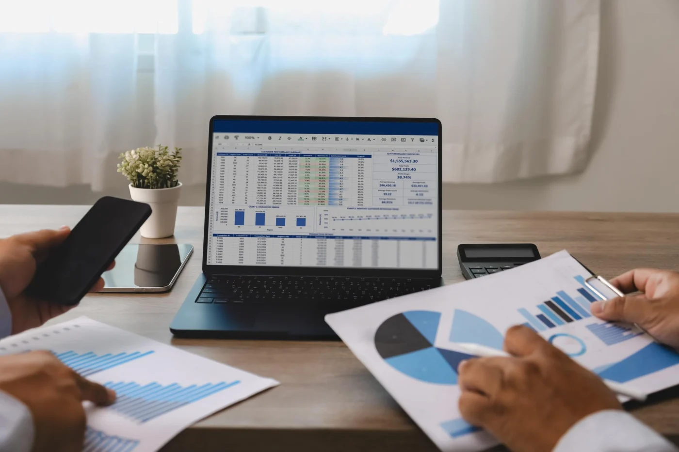 An accountant reviewing financial reports on a laptop