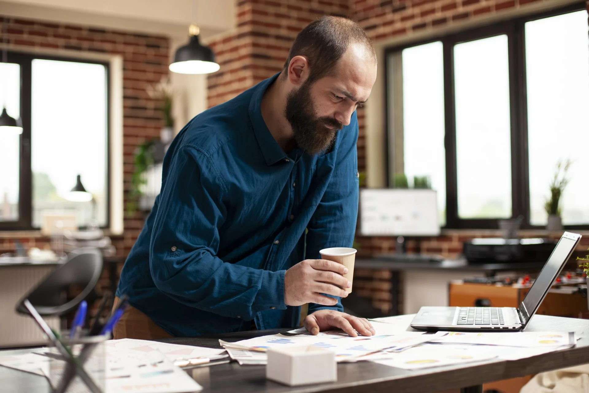 A business owner reviewing accounts and tax figures at a desk