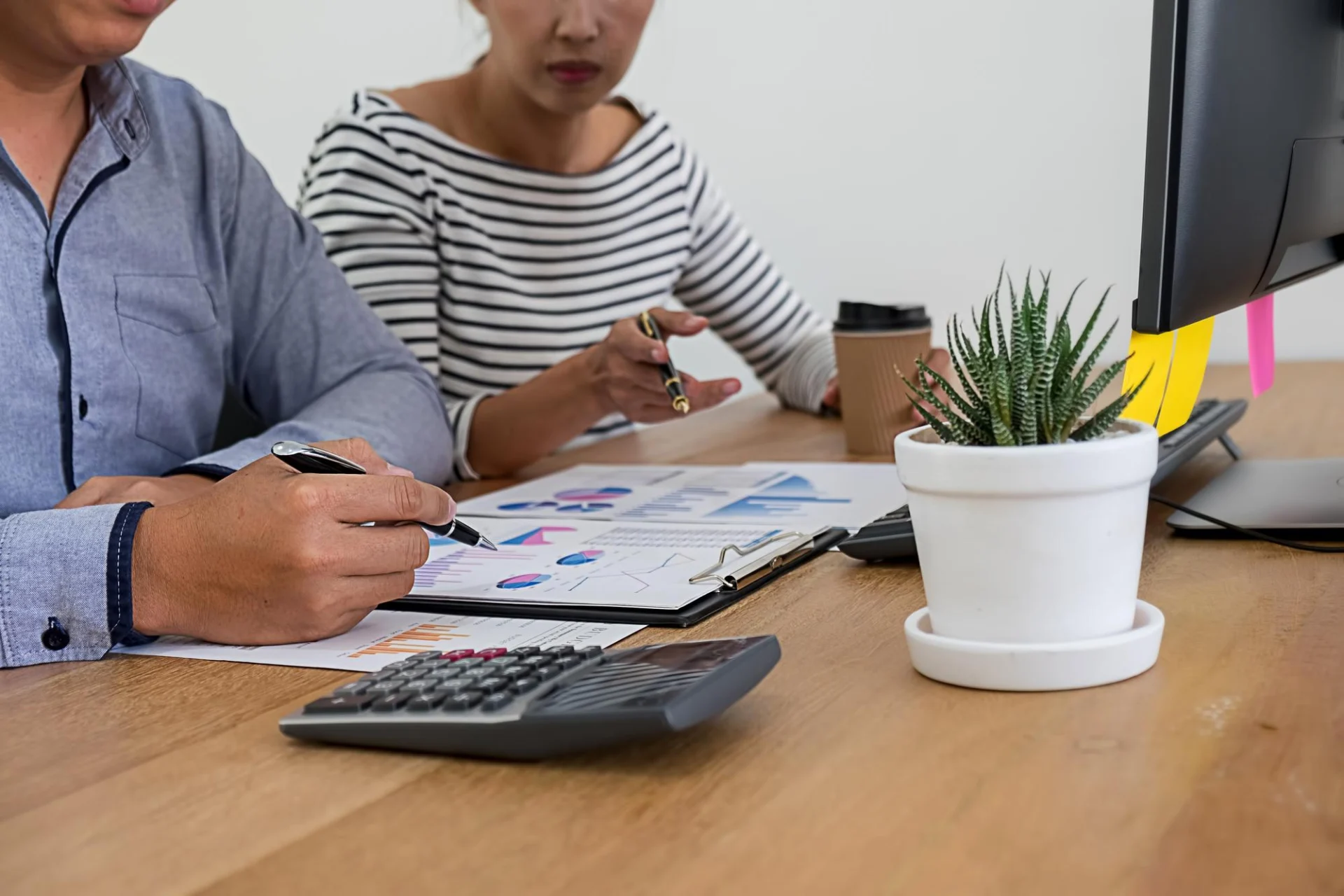 A small business owner reviewing accountancy fees with an adviser