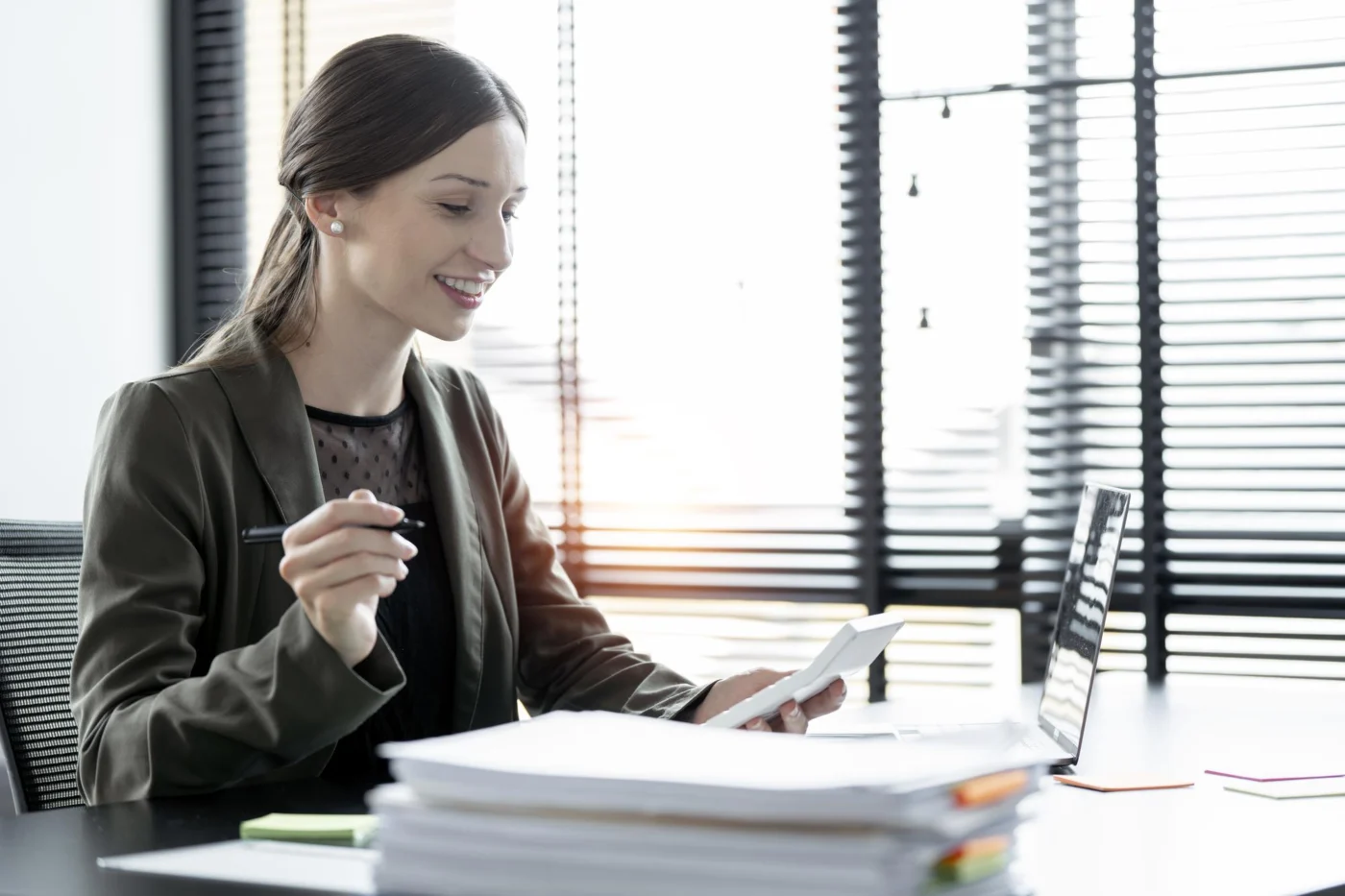 A professional reviewing documents at an office desk