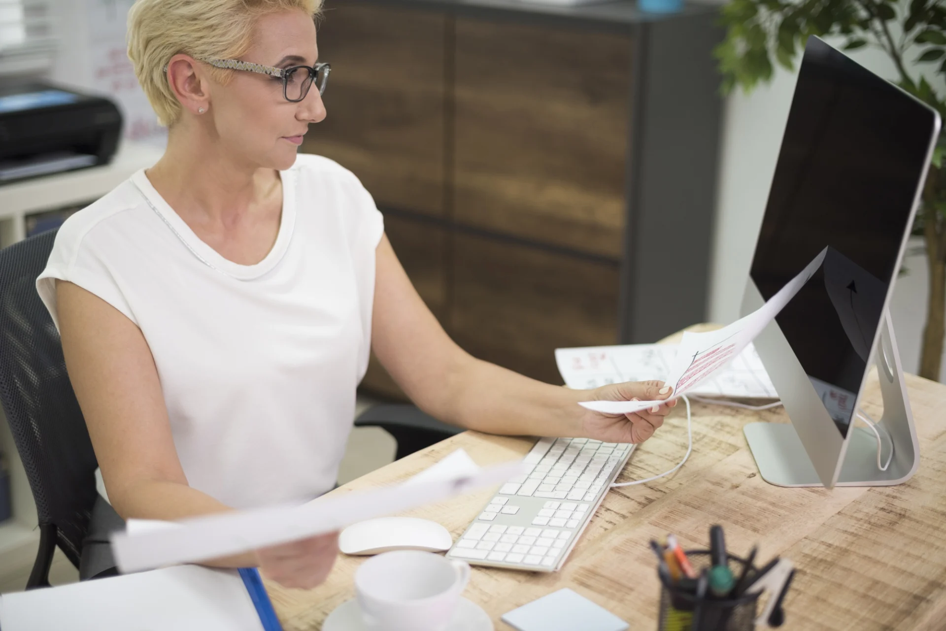 A payroll administrator processing pay in an office