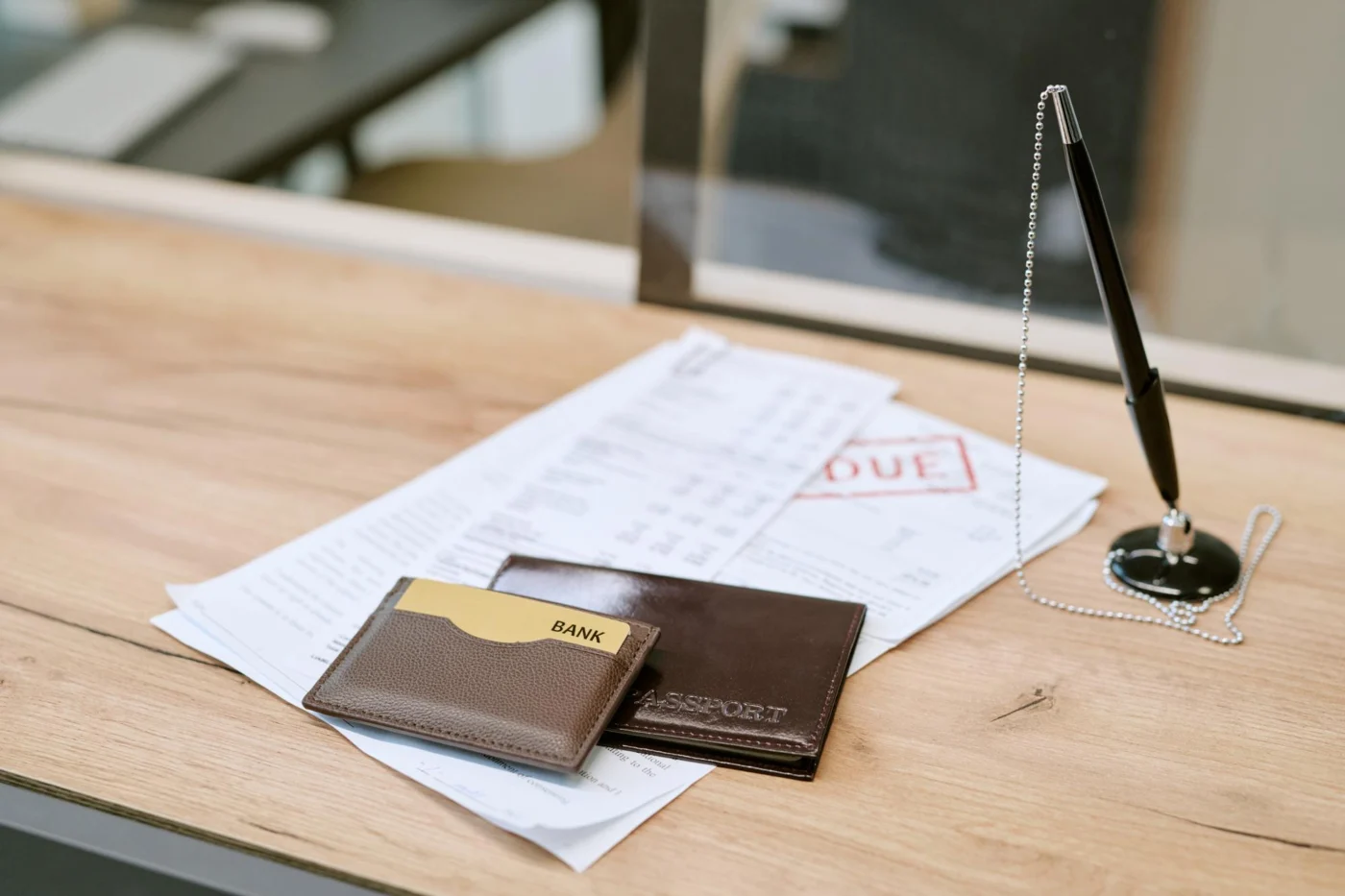 Company documents, a passport and proof of identity laid out on a desk for a bank application