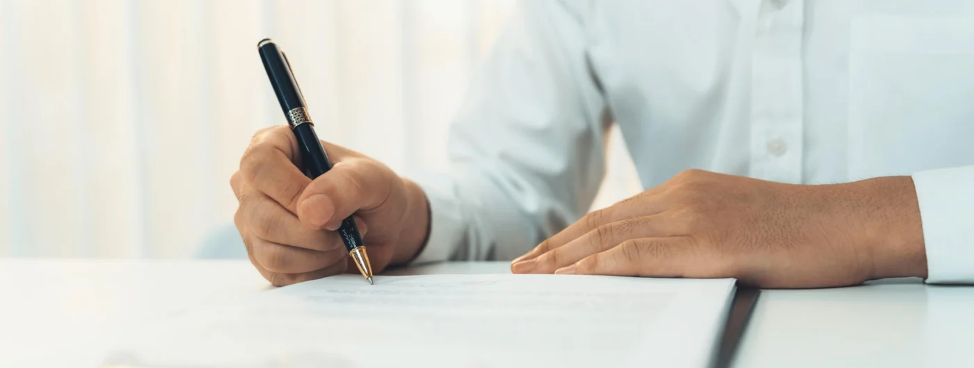 A signed corporate document and pen on a desk