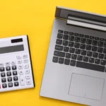 A business owner filing their tax return online at a laptop in an office