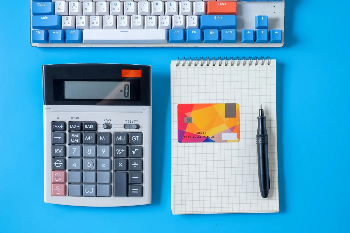 A close-up of a calculator resting on printed company accounts