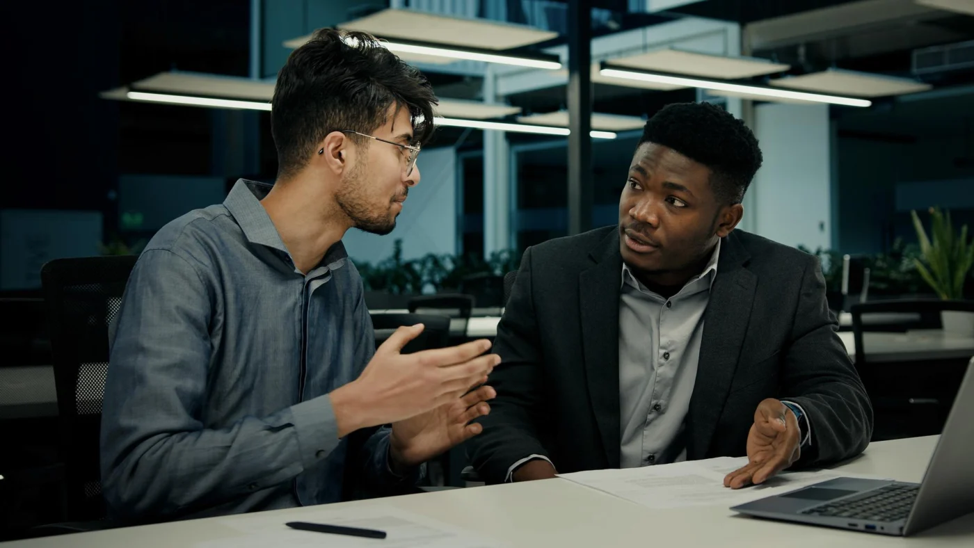 A business owner and a finance adviser discussing figures together