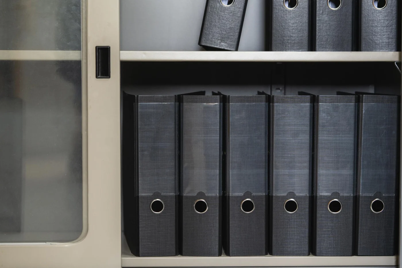 A company secretary reviewing corporate ownership records at a desk