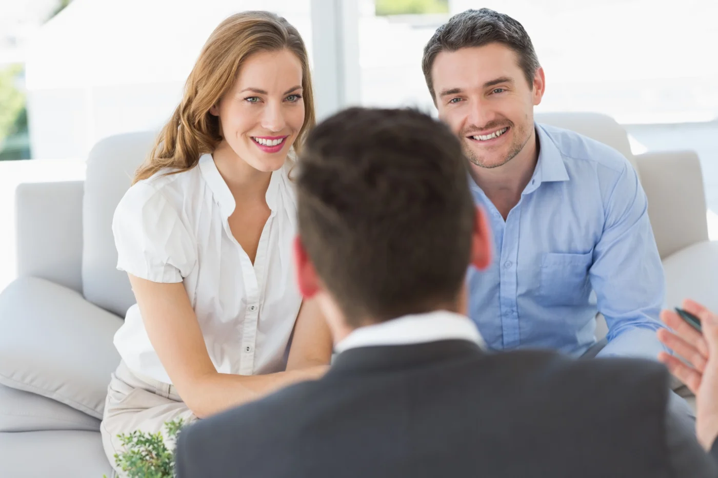 An individual discussing their tax residence with an adviser across a desk
