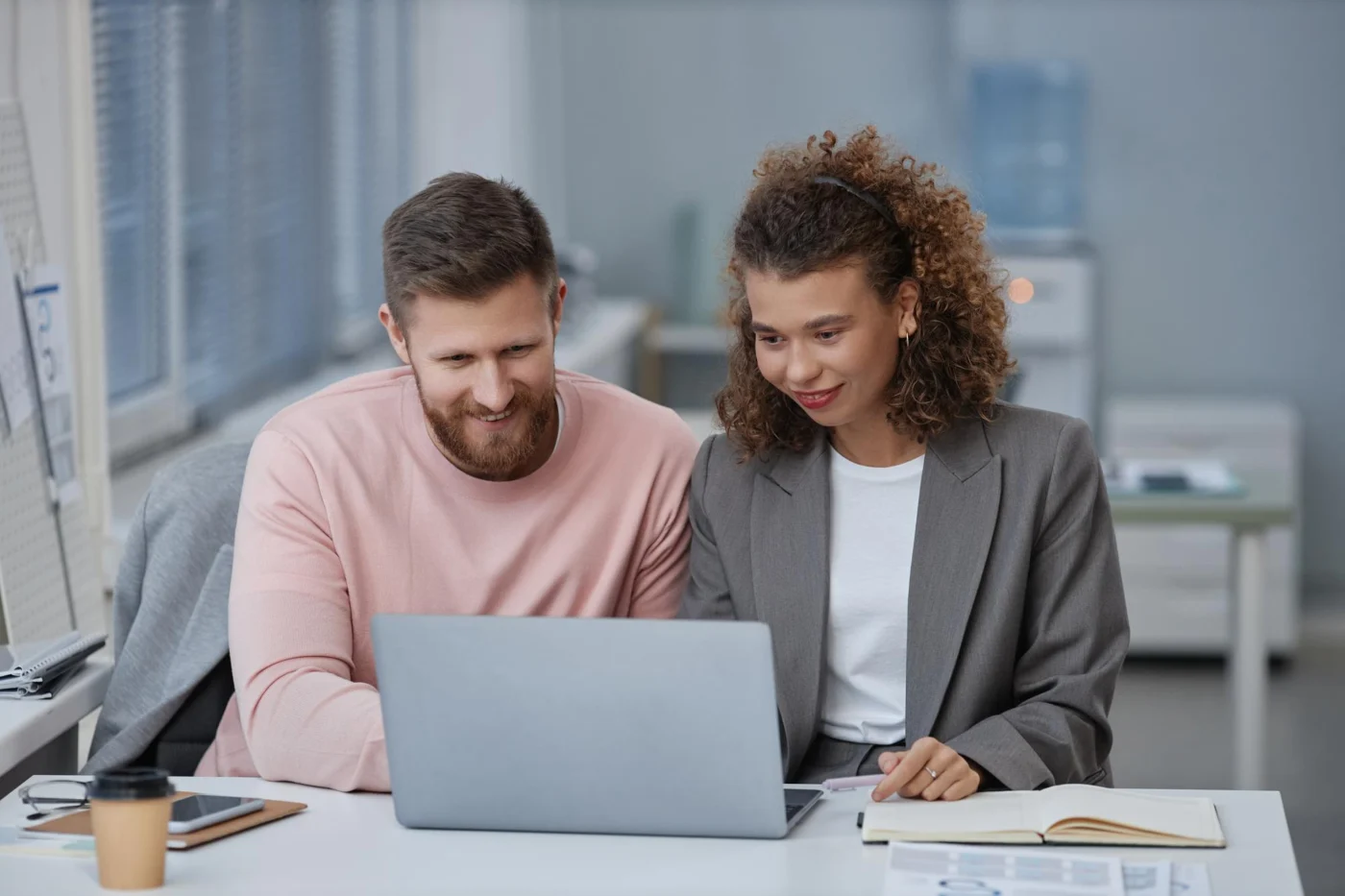 Two advisers reviewing a company ownership chart on a laptop