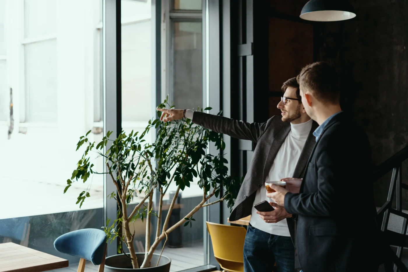 Two business owners talking over paperwork in a bright office