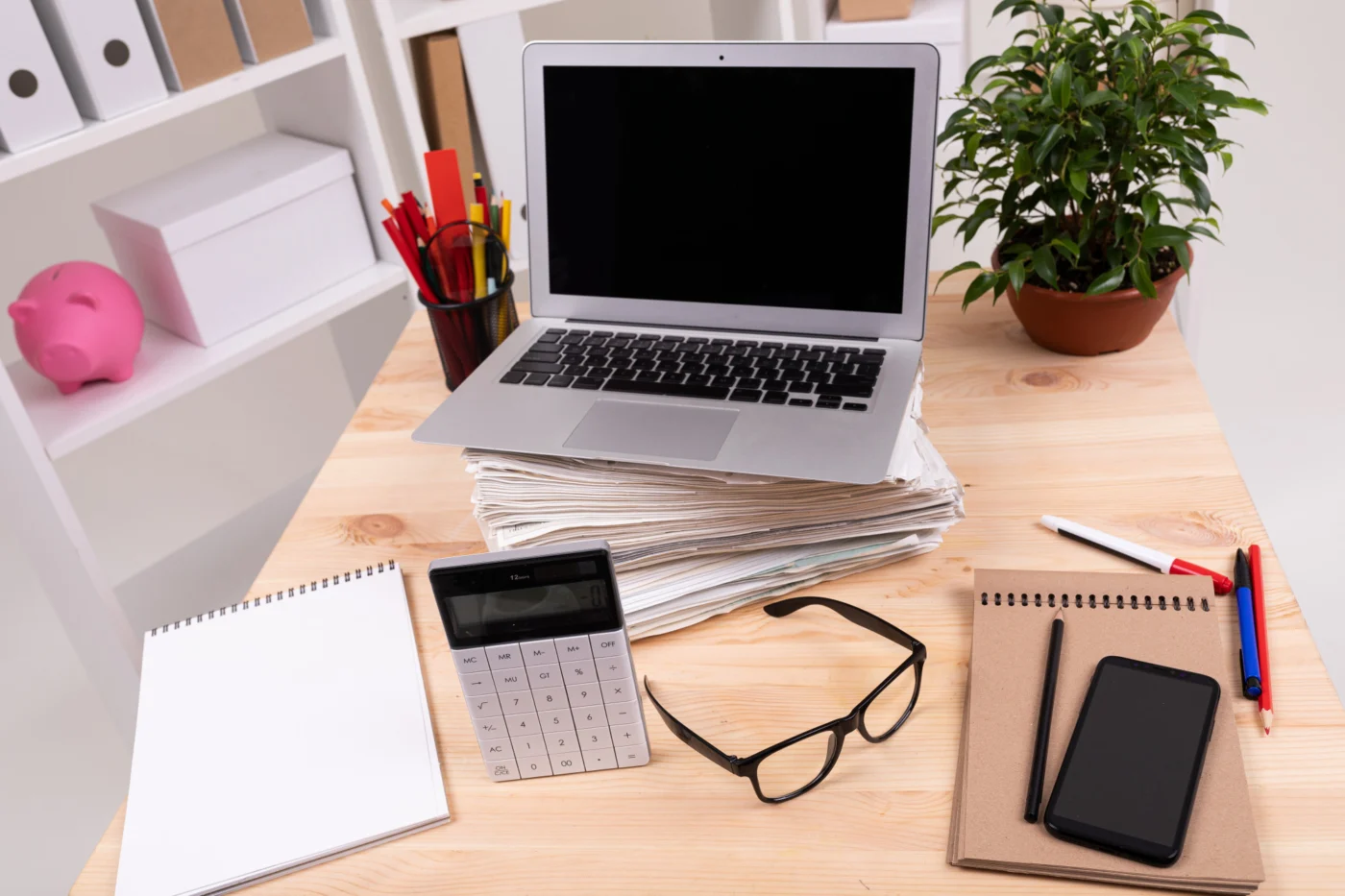 A tidy modern office desk with a laptop and organised documents