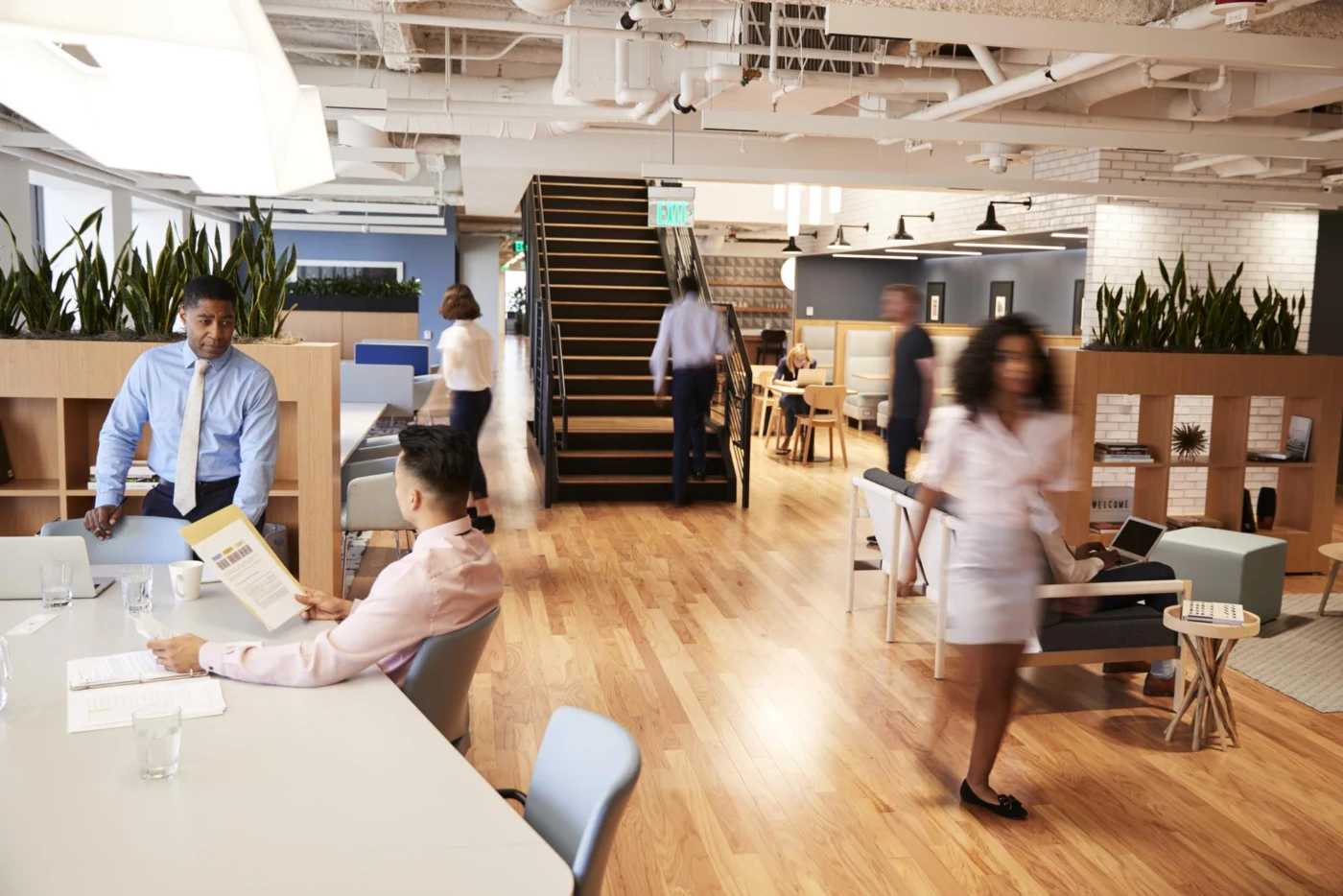 A calm modern office interior with people working