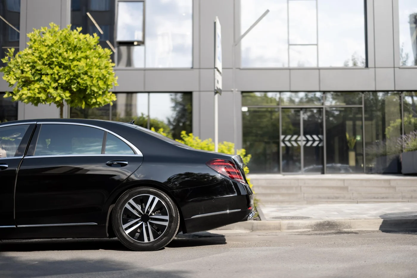 A company car parked outside a modern office building