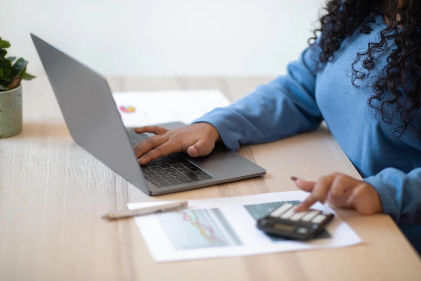 Two business people reviewing accounts on a laptop in a bright office