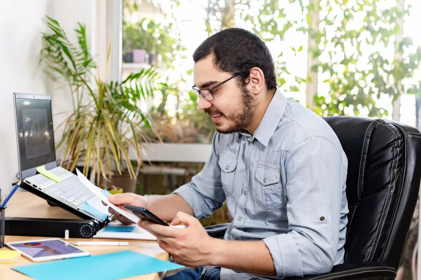 A business owner working through company paperwork at a desk