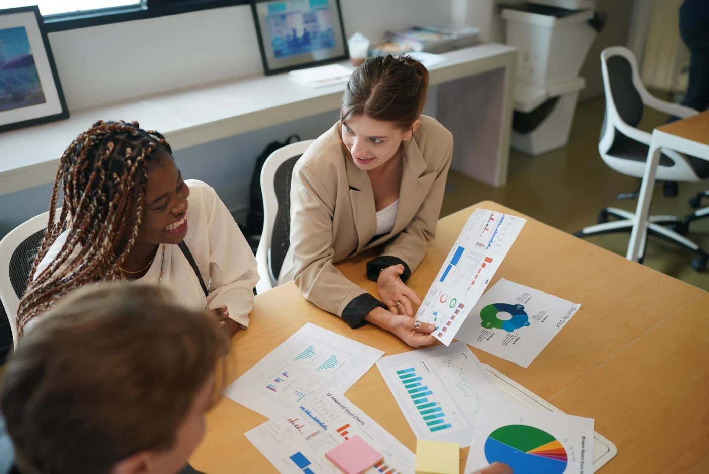 A team reviews a household budget spreadsheet together around a table
