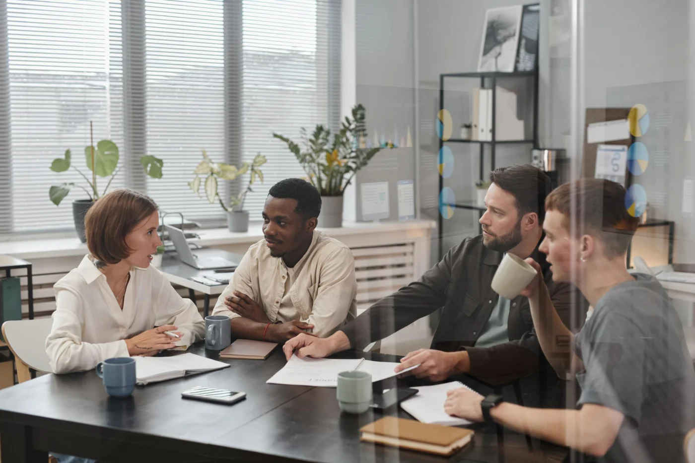 Colleagues discuss a policy briefing around a meeting table