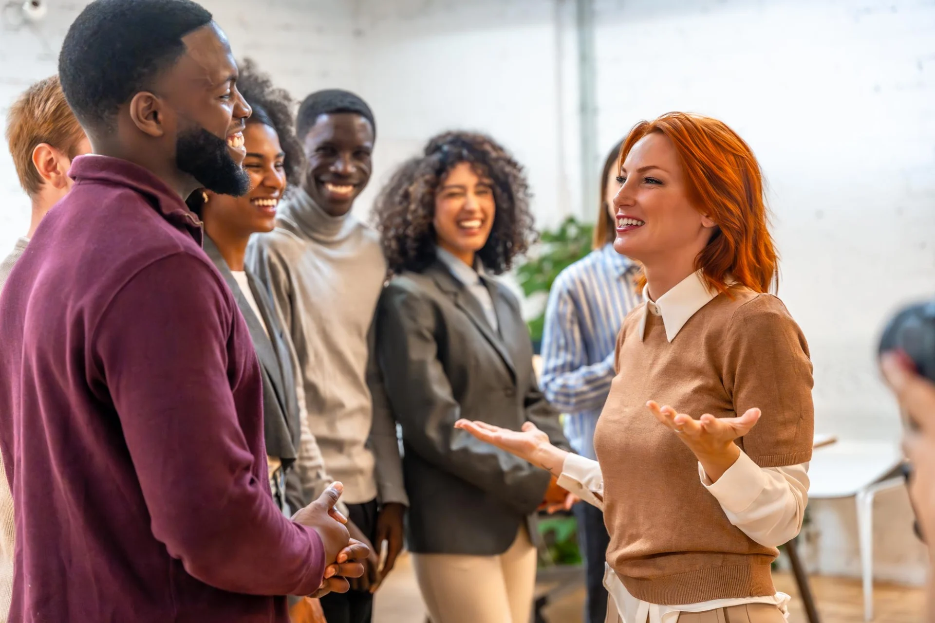 Colleagues welcoming a new team member in a modern office